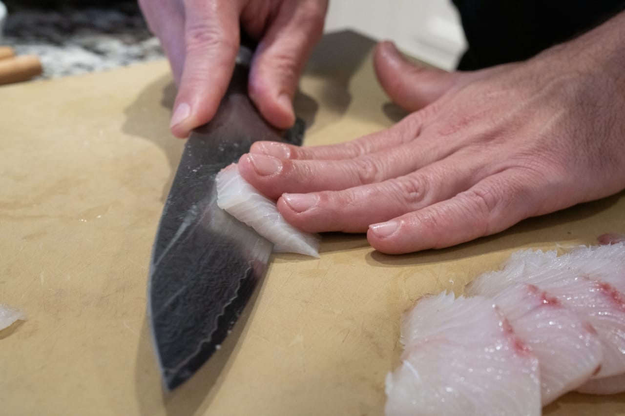 Hand shaping sushi.