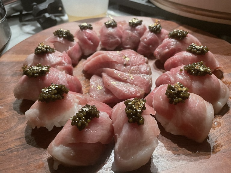 Signature nigiri on slate.